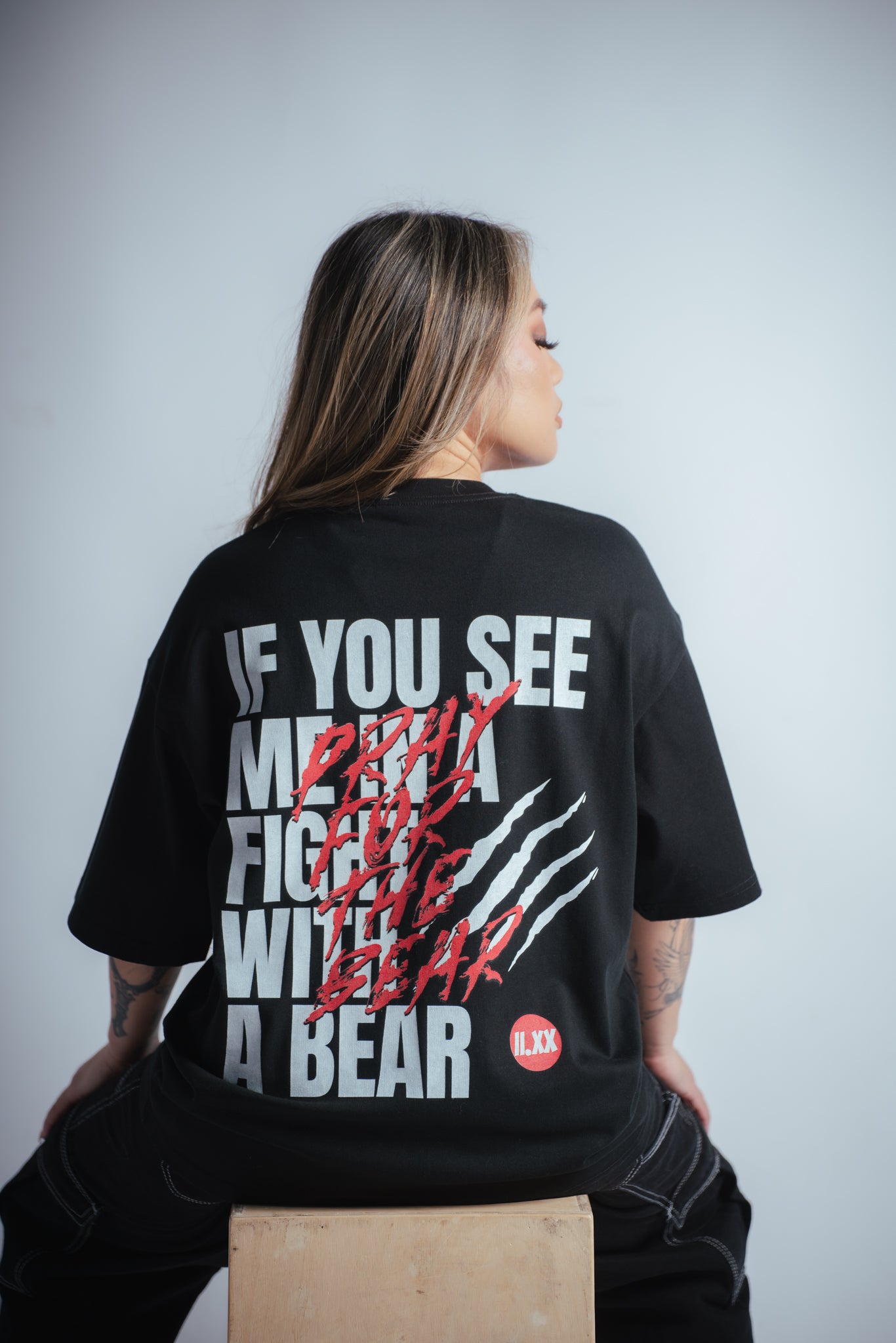 close up view of the bear fight tshirt worn by female model