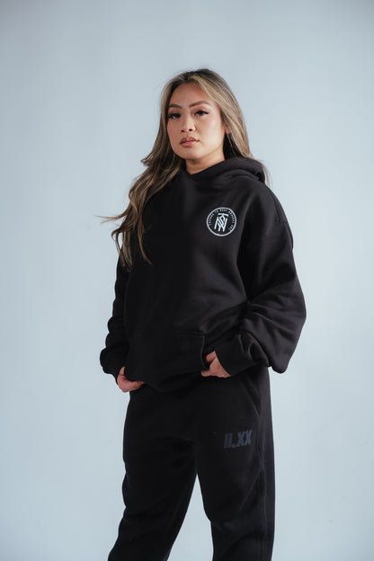 female model showing the front of the no risk relaxed hoodie