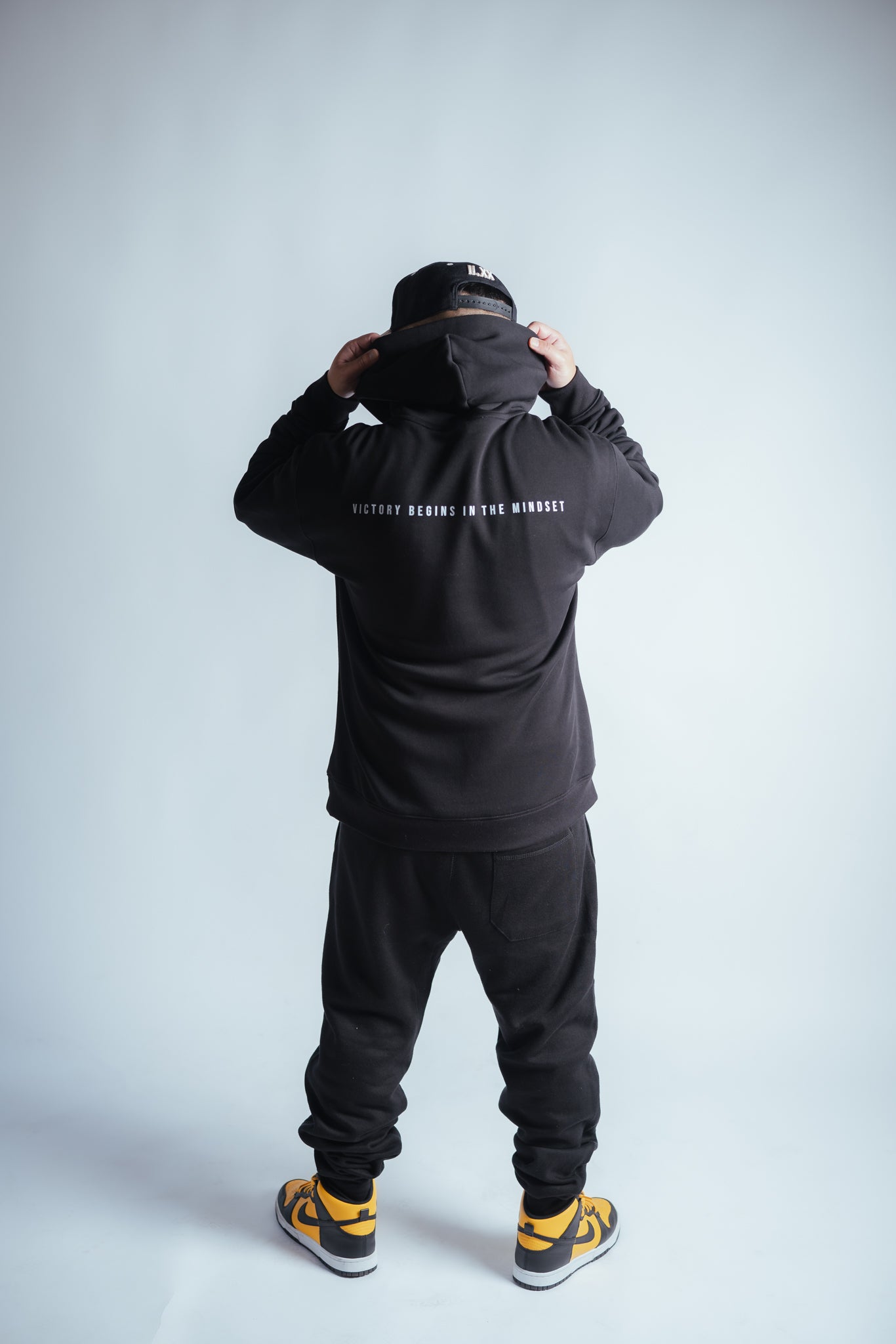 male model showing the victory relaxed hoodie back graphic