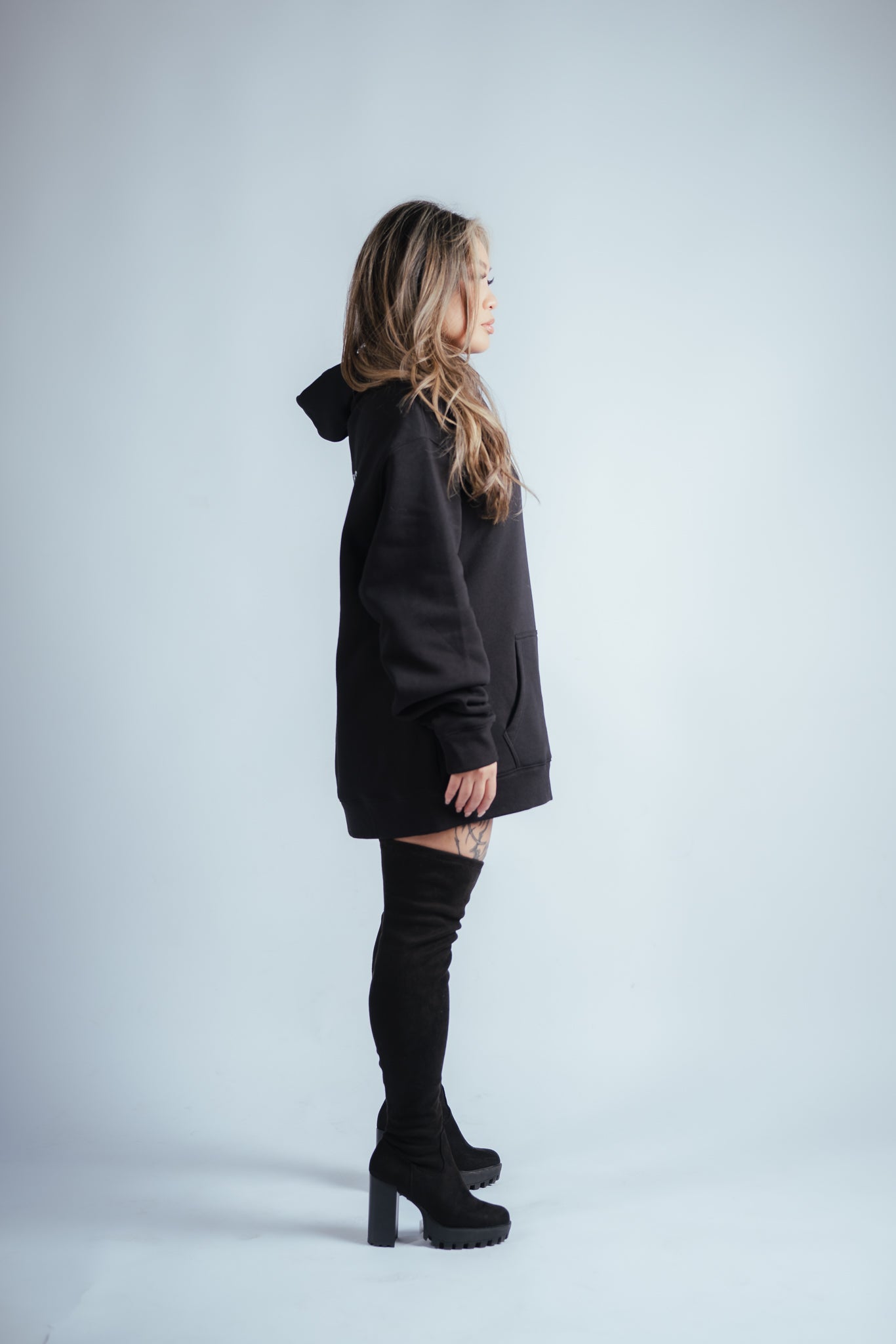 female model wearing the victory relaxed hoodie side profile view