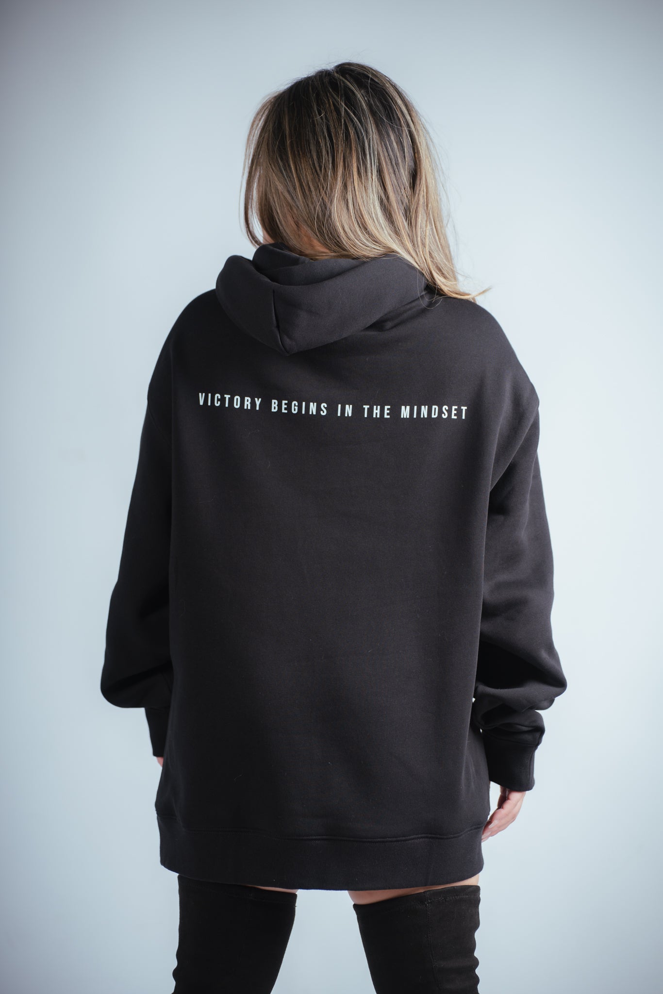 close up of female model wearing the victory relaxed hoodie showing the back